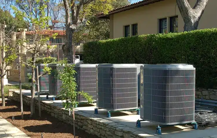 Air-Tro technicians setting a new condenser during AC installation in Monrovia