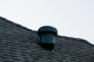 Quiet modern whole house fan mounted in a residential ceiling for energy-efficient cooling